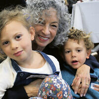 Mitzvah Day chair Rachel Weiss of Franklin Lakes holds her grandchildren, Flora and Amos Weiss.