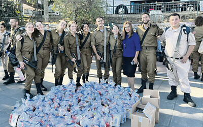 IDF soldiers receiving mishloach manot baskets for Purim from the Kever Rachel Heritage Fund