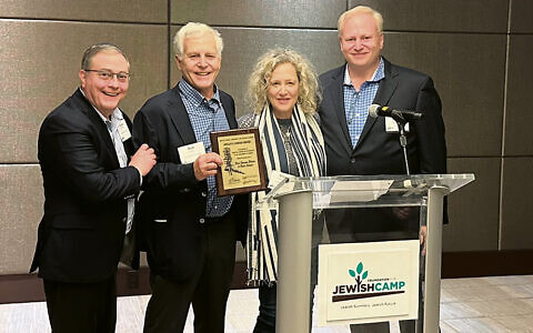 ON THE COVER: Scott Brody, right, the immediate past chair of the American Camp Association and a Federation of Jewish Camp board member, presents the ACA’s Hedley S. Dimock award to Elisa and Rob Bildner as Jeremy Fingerman, FJC’s CEO, at left, looks on.