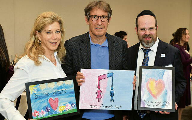 Above, Michele Mirman and Joe Sprung, the president and chairman and founder of Bear Givers, are with Sinai’s Leo Brandstatter z”l Dean Rabbi Dr. Yisrael Rothwachs at the May 19 student art show.