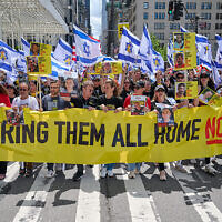 The Jewish Community Relations Council of New York, which organized the march, remembered the hostages with its signs. The Jewish Community Relations Council of New York, which organized the march, remembered the hostages with its signs.