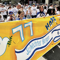 Schechter Bergen students walk behind their banner. Schechter Bergen students walk behind their banner.