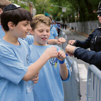 Students from SAR in Riverdale fist-bump with police officers. Students from SAR in Riverdale fist-bump with police officers.