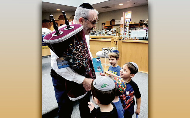 Rabbi Jonathan Knapp shows a sefer Torah to young students. (All photos courtesy Yavneh Academy) Rabbi Jonathan Knapp shows a sefer Torah to young students. (All photos courtesy Yavneh Academy)