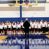Moriah’s choir sings for the first time in the new athletic center.