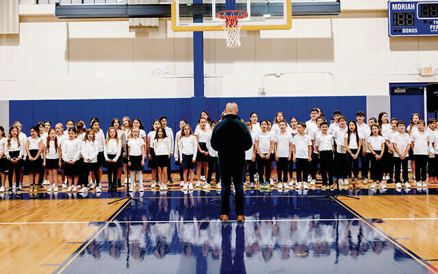 Moriah’s choir sings for the first time in the new athletic center.