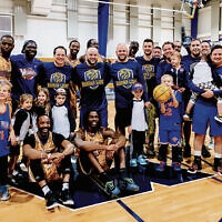 The Harlem Wizards, the Moriah dads, and some of their kids are together in the new gym.