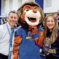 Head of school Rabbi Daniel Alter and midle school associate principal Tzipporah Boim stand with the new school mascot, the Moriah Lion.