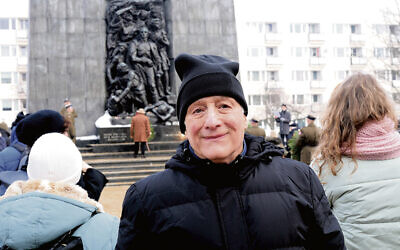 Dr. Ravid stands in front of the monument.