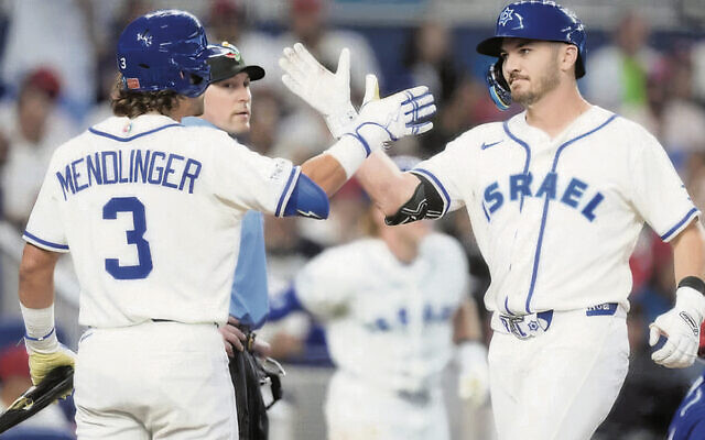 Noah Mendlinger congratulates designated hitter Spencer Horwitz, right, on March 9, after Horwitz’s home run against the Dominican Republic during the fourth inning of a World Baseball Classic game in Miami.