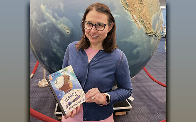 Margie Gurevich holds a copy of her book at the Fair Lawn Public Library.