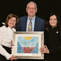 Diane, left, and Ron Strobel receive a work of art created by a Sinai student from Esther Lerer, Sinai vice president and a long-time member of its executive committee and bsoard. Diane, left, and Ron Strobel receive a work of art created by a Sinai student from Esther Lerer, Sinai vice president and a long-time member of its executive committee and bsoard.