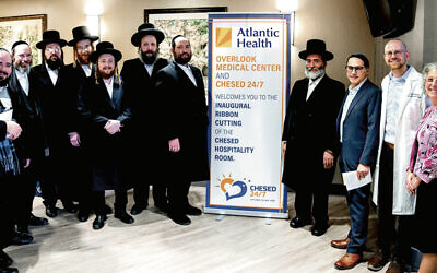From left: Jacob Taub, Aaron Taub, Abraham Moskowitz, Mutty Miller, Avromy Herbst, Rabbi Mordcha Teitelbaum, Yossi Greenberg, Rabbi Shulem Greenberg, Dr. Devon Klein, Dr. David Hoffman, and Stephanie Schwartz are at the opening. (Yaakov Sebbag)