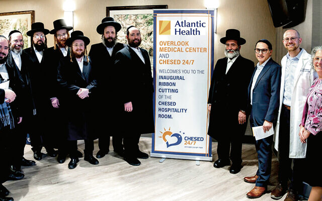 From left: Jacob Taub, Aaron Taub, Abraham Moskowitz, Mutty Miller, Avromy Herbst, Rabbi Mordcha Teitelbaum, Yossi Greenberg, Rabbi Shulem Greenberg, Dr. Devon Klein, Dr. David Hoffman, and Stephanie Schwartz are at the opening. (Yaakov Sebbag)