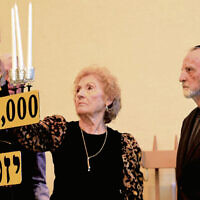 Honoree Betty Scharf lights a candle. She was escorted by her cousin, Vladi Brunstein.