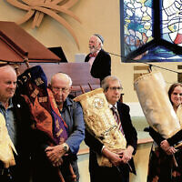 From left:  Dr. Charles Knapp (Congregation B’nai Sholom/Fair Lawn Jewish Center), Seymour Schlossberg (Shomrei Torah-Wayne), Rabbi Ronald Roth (CBS/FLJC), Rabbi Jennifer Schlosberg (Glen Rock Jewish Center), and David Schwartz (Temple Beth Rishon) hold Czech sifrei Torah as Steven Skybell and Zalmen Mlotek sing the Partisan Hymn.