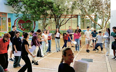 Gabrielle Soffer Cohen, foreground, teaches her class English grammar through an outdoor skit designed to add movement to the lessons.