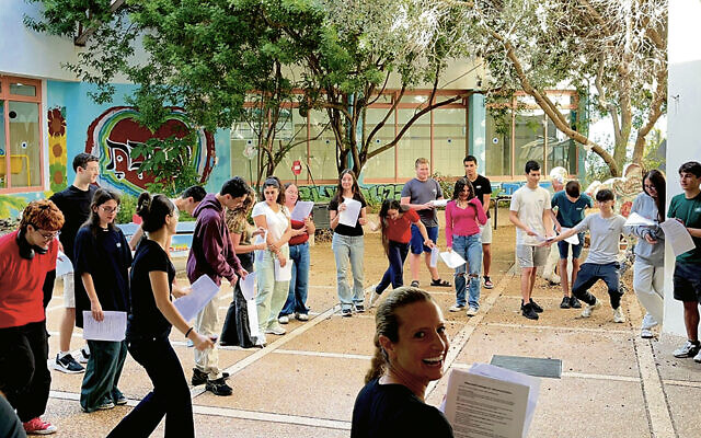 Gabrielle Soffer Cohen, foreground, teaches her class English grammar through an outdoor skit designed to add movement to the lessons.