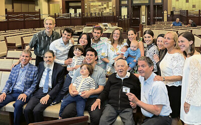 Henry Glenn is surrounded by his family, including three sons, 12 grandchildren, and 14 great-grandchildren.