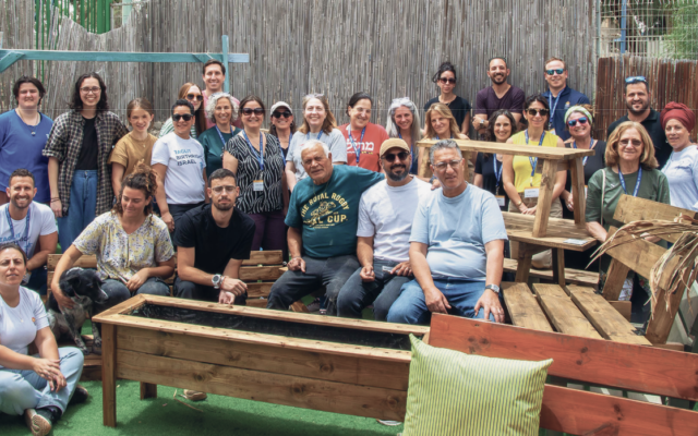 Members of the Jewish Service Alliance Israel Service Seminar sit on some of the furniture they built in Dimona.