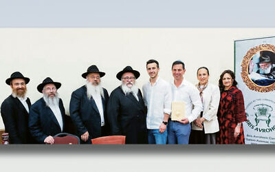 From left: Rabbi Avremy Kanelsky, Rabbi David Wilansky, Rabbi Mendel Groner, Rabbi Mordechai Kanelsky, Lenny Kanchik, Felix and Lina Kanchik, and Rebbetzin Shterney Kanelsky