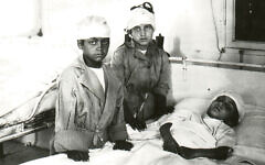 Two wounded boys visit a worse-hurt friend in Hebron in 1929. (All photos courtesy Yardena Schwartz)