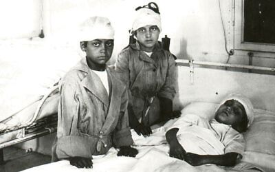 Two wounded boys visit a worse-hurt friend in Hebron in 1929. (All photos courtesy Yardena Schwartz)