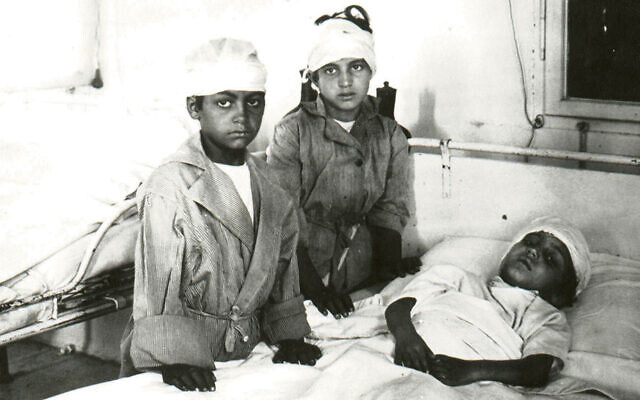 Two wounded boys visit a worse-hurt friend in Hebron in 1929. (All photos courtesy Yardena Schwartz)