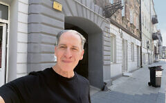 Mr. Chernoff stands in front of one of the places his mother lived in the Tomaszow ghetto.