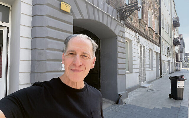 Mr. Chernoff stands in front of one of the places his mother lived in the Tomaszow ghetto.