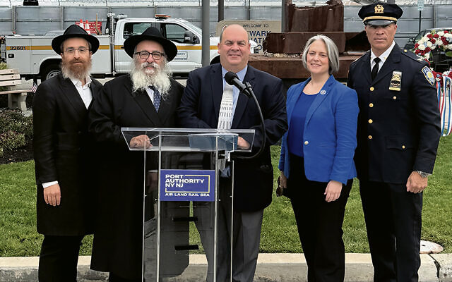 Rabbis Avremy Kanelsky and Mordechai Kanelsky, left, with Frank Radics, manager of physical plant and redevelopment for the New Jersey airports at Port Authority of New York & New Jersey; Sarah McKeon, director of the Port Authority’s aviation department; and Michael Belcher, deputy inspector of the PATH Command for the Port Authority police department. (Courtesy Bris Avrohom)