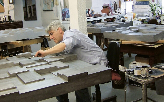 Tobi Kahn is at work in his studio.