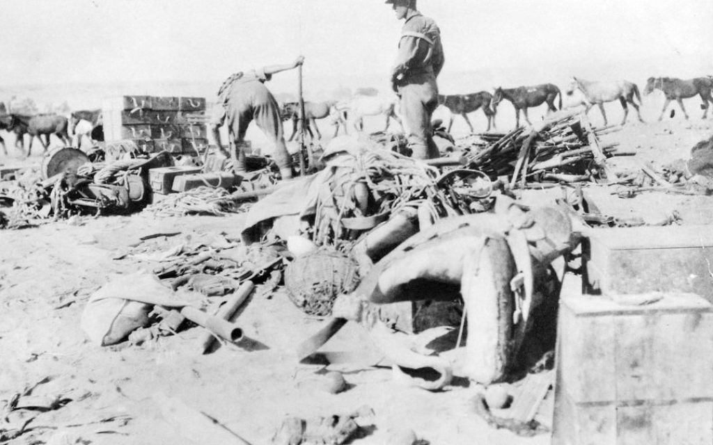 Members of the 12th Light Horse regiment survey damaged items and captured Turkish equipment from the battle of Beersheba.
Courtesy of Australian War Memorial