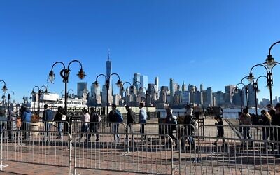 Masked tourists line up at Liberty State Park in New Jersey for the ferry to Liberty Island, Dec. 26, 2021. (Jewish Week)