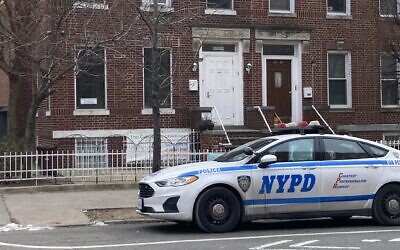 An NYPD patrol car parked outside the Sunnyside Jewish Center in Queens on Sunday, Jan. 16, 2022. The city deployed additional resources to Jewish locations around the city on Saturday night as the hostage crisis at a Dallas-area synagogue unfolded. (Lisa Keys)
