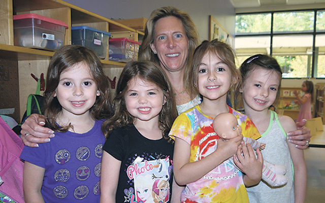 Amy Nelson with youngsters at JCC MetroWest’s preschool, where she became director on May 1.     