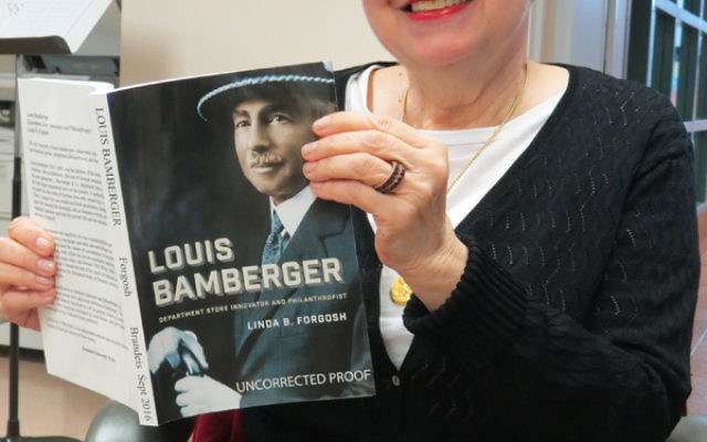 Linda Forgosh, director of the Jewish Historical Society of NJ, holds her book, Louis Bamberger: Department Store Innovator and Philanthropist.