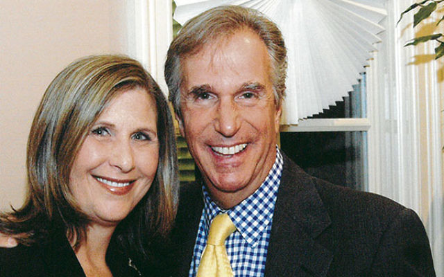 At a 2004 federation event, Bamira greets actor Henry Winkler, the son of Holocaust survivors, who spoke about his commitment to helping children with special needs.