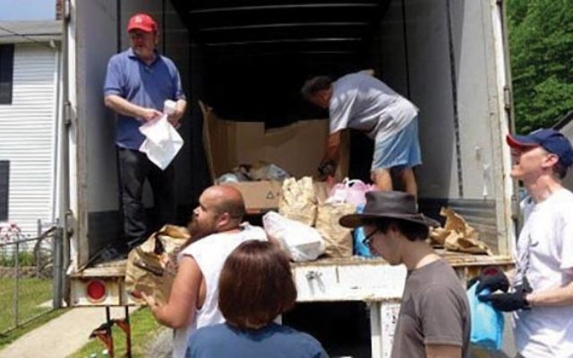 Rabbi Steven Bayar, left, and volunteers from B’nai Israel in Millburn help unload a 53-foot food truck with donated canned goods and other foodstuffs for the residents of McRoberts, Ky. Photo Courtesy Glenn Rosenkrantz