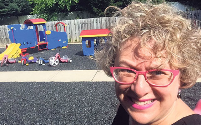 Anne Berman-Waldorf, director of lifelong education at Congregation Beth Chaim, in front of the preschool’s playground. “We see the potential in every child,” she said. 