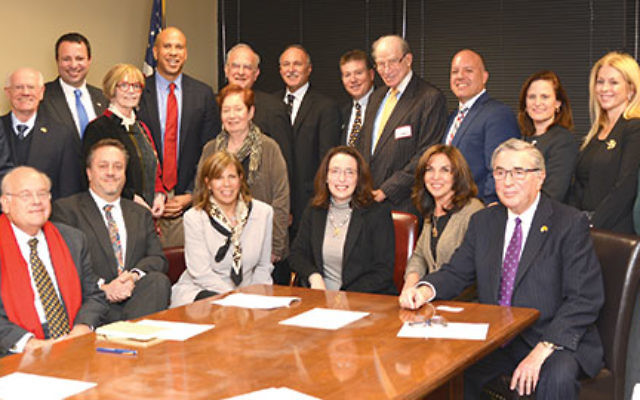 Meeting with Sen. Cory Booker, standing, fifth from left, are State Association board members and federation leaders, from left, front row, Roger Jacobs (Jewish Federation of Greater MetroWest NJ); Eric Lavitsky (Jewish Federation of Somerset Hunterdon Wa