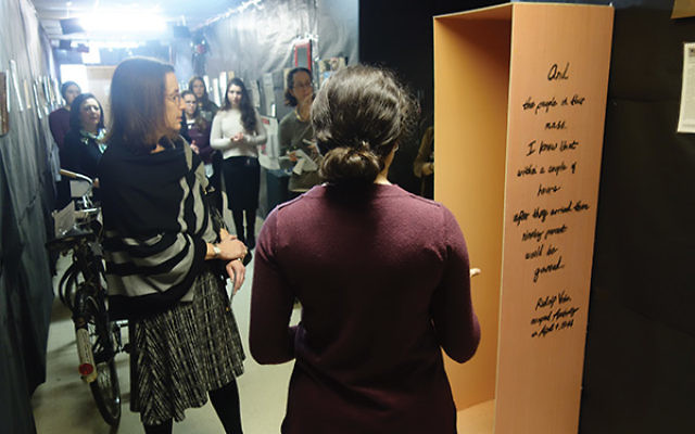 Leslie Dannin Rosenthal, left, looks at a box built to simulate the amount of space Jews may have been confined to in cattle cars. Photo courtesy Adina Abramov/Bruriah