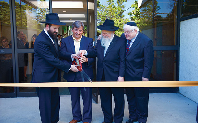Taking part in the ribbon-cutting ceremony of the new Chabad of West Orange in June 2016 are, from left, Rabbi Mendy Kasowitz, Mayor Robert Parisi, Rabbi Moshe Herson, and Jed Katz. Photo by Harry Vine