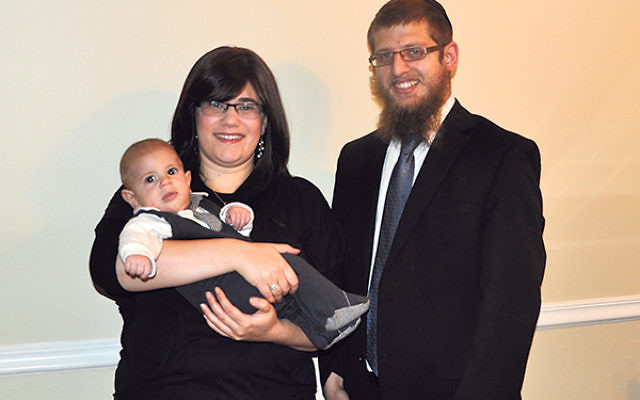 Rabbi Yaakov and Chana Chaiton — with son Levi — at their home in Hamilton.    
