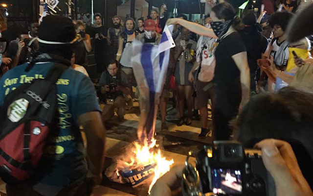 Protestors burning an Israeli flag outside the Democratic convention in Philadelphia, July 26, 2016. (Screenshot from Twitter)