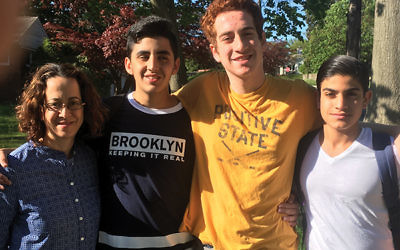 The author, at left, and her family shared New Jersey Jewish life with guests from the Greater MetroWest NJ partnership community of Merchavim. Her son, Gidi Fox, center, is flanked by Oriyan and Ran.