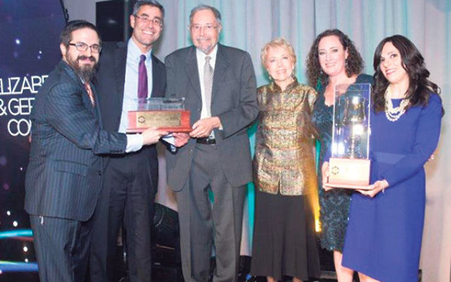 Rabbi Zalman Grossbaum, left, and his wife, Toba, right, with Friendship Circle annual banquet honorees, from left, Gerald Cohen, Dr. Herbert Cohen, Marion Cohen, and Elizabeth Cohen.     