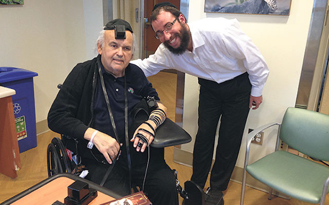 The late Howard Feinstein, wearing tefillin, with Rabbi Zalman Notick. 