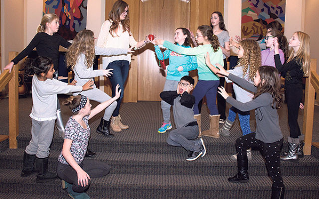 Young people rehearse as Queen Vashti attempts to give King Ahashverosh a poison apple during the Purimshpiel based on Disney’s The Descendants.
