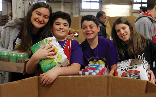 Students volunteering at the Community FoodBank of NJ helped sort boxes of food to be distributed to food pantries, shelters, and soup kitchens. 